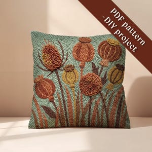 May include: Square decorative pillow with a textured, embroidered design featuring stylized orange, brown, and yellow flowers on a teal background. The pillow has a floral pattern and the text "PDF pattern - DIY project" in a diagonal brown banner.