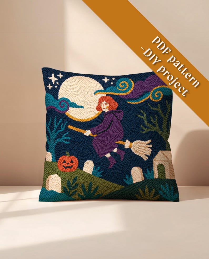 May include: A square throw pillow featuring a needlepoint design of a person with red hair flying on a broomstick against a dark blue night sky with a large moon, a jack-o'-lantern, and tombstones. The text PDF pattern - DIY project is visible.