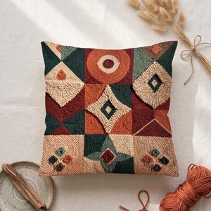 May include: A square throw cushion featuring a textured punch needle design with a geometric pattern of squares and diamonds. The colour palette includes shades of deep green, burnt orange, maroon, and cream, creating a multi-layered visual effect.