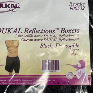 Puede incluir: Boxers DUKAL Reflections negros desechables. El embalaje incluye el nombre de la marca, los detalles del producto y un código de barras. El producto está etiquetado como grande. El embalaje también incluye el texto "Spa".