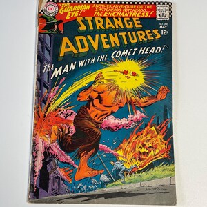 May include: A comic book cover featuring a man with a comet head, running through a city with flames and smoke. The cover is for Strange Adventures #200, May 1967, and features the text "The Man With The Comet Head!"