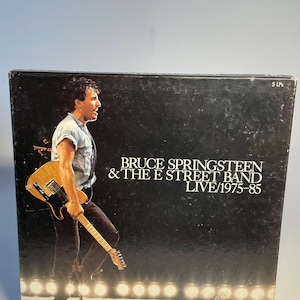 Promoción de discos de vinilo vintage de Bruce Springsteen & the E-Street Band en vivo, 1975-1985, con 5 LP y 2 folletos de varias páginas a todo color