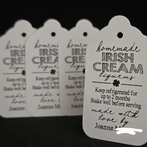 May include: Four white gift tags with black text that reads "homemade Irish cream liqueur". The tag also includes instructions to keep refrigerated for up to 2 months and to shake well before serving. The tag is signed "made with love by Joanne".
