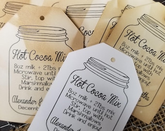 May include: White gift tags with a black and white illustration of a mason jar with the text "Hot Cocoa Mix" and instructions for making hot cocoa. The text also includes the names "Alexander & Samantha" and the date "December 2019".