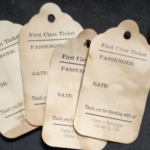 May include: A stack of vintage-style paper tags with a scalloped top and a hole for stringing. The tags read "First Class Ticket" and include space for passenger and gate information. The text "Thank you for traveling with us!" is also printed on the tags.