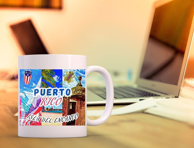 May include: White ceramic mug with a colorful design featuring a Puerto Rican flag, a frog, a building, and the text "PUERTO RICO ISLA DEL ENCANTO".