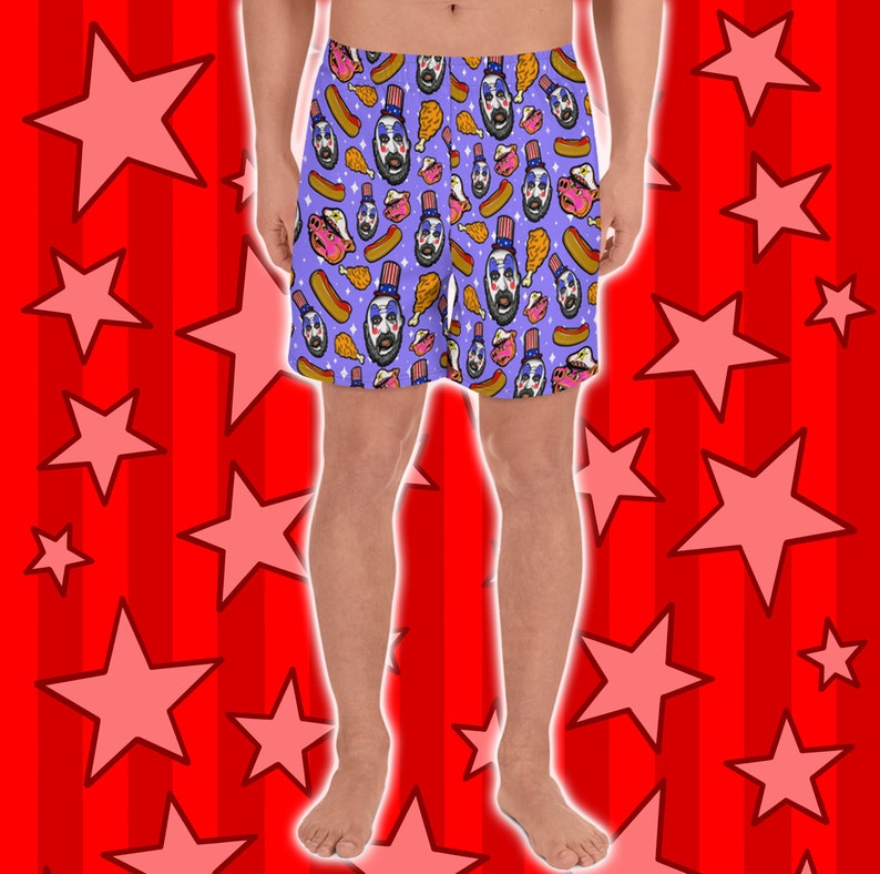 May include: Purple boxer shorts with a repeating pattern of a cartoon character wearing a red, white, and blue hat and a variety of food items, including hot dogs, fried chicken, and cupcakes.