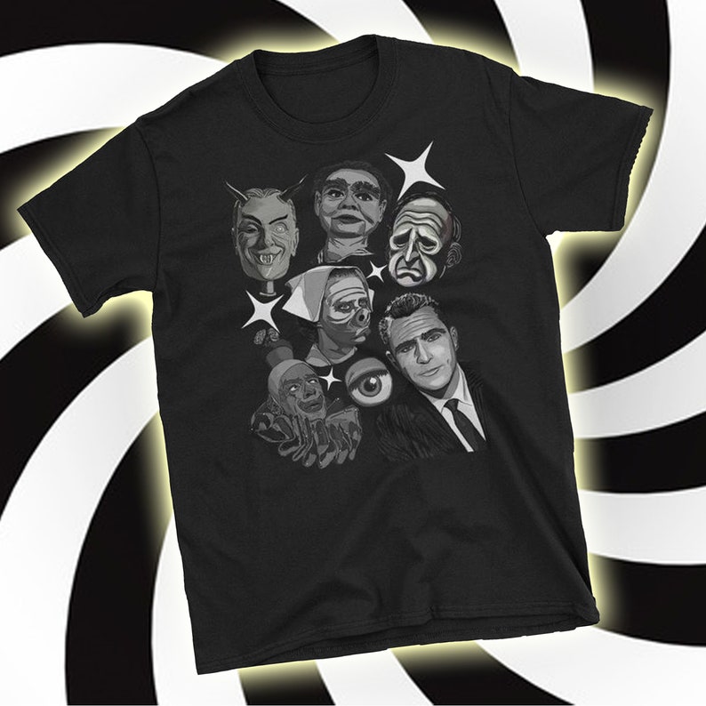 May include: Black t-shirt featuring a grayscale illustration of various classic horror movie characters. The design includes images of a devil, a ventriloquist dummy, and other iconic figures. The shirt has a crew neck and short sleeves.