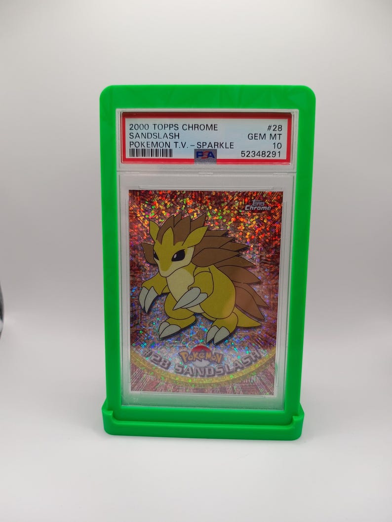 May include: A graded Pokemon trading card featuring Sandslash from the 2000 Topps Chrome Pokemon T.V. - Sparkle series. The card is graded Gem Mint 10 and has a PSA number of 52348291.