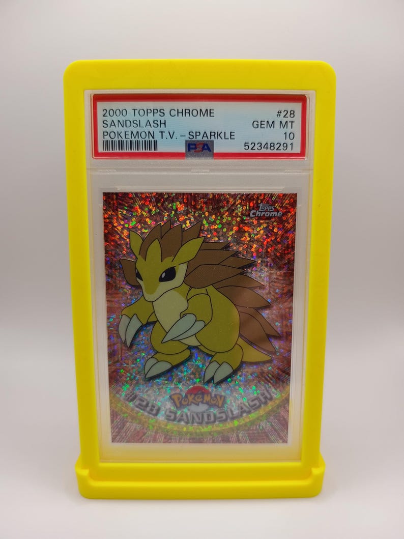 May include: A graded Pokemon trading card featuring Sandslash from the 2000 Topps Chrome Pokemon T.V. - Sparkle series. The card is graded GEM MT 10 and has a PSA number of 52348291.