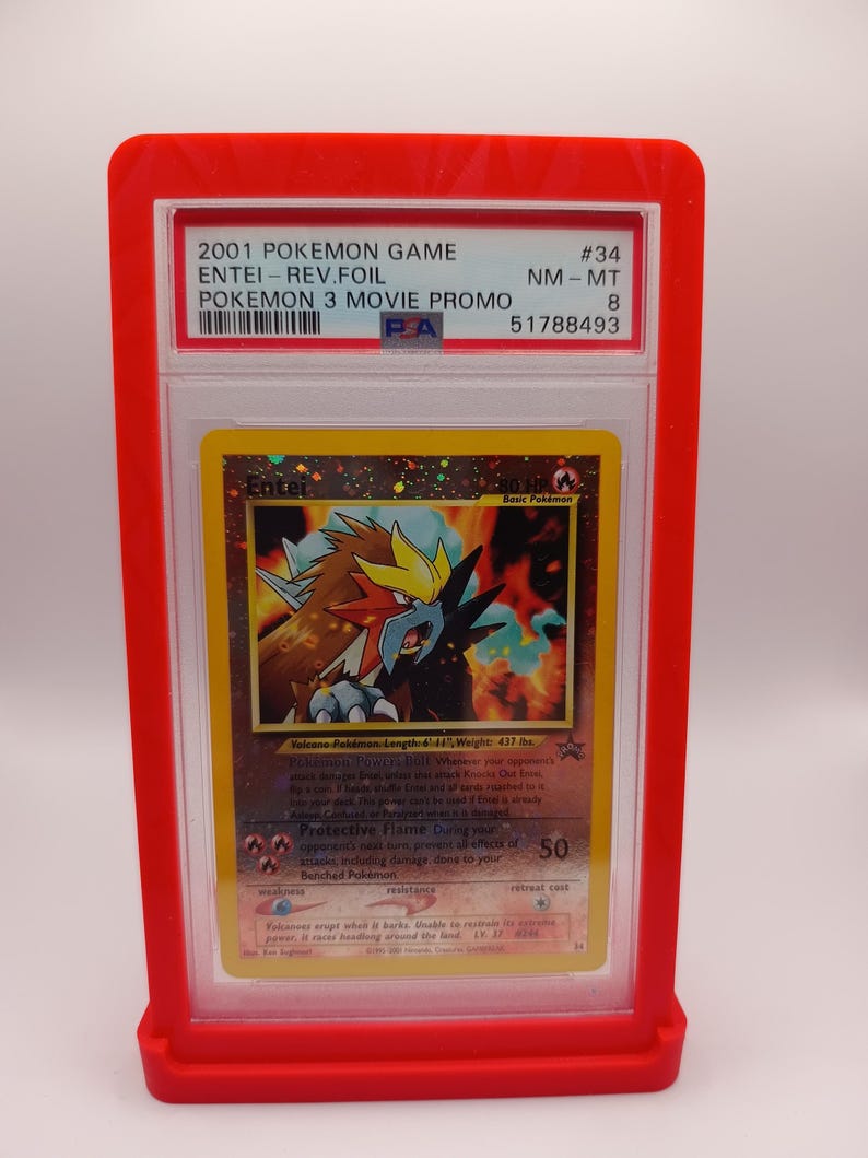 May include: A graded Pokemon trading card featuring Entei from the Pokemon 3 Movie Promo set. The card is in near mint condition and has a PSA 8 grading. The card is a holographic card with a red, orange, and yellow colour scheme.