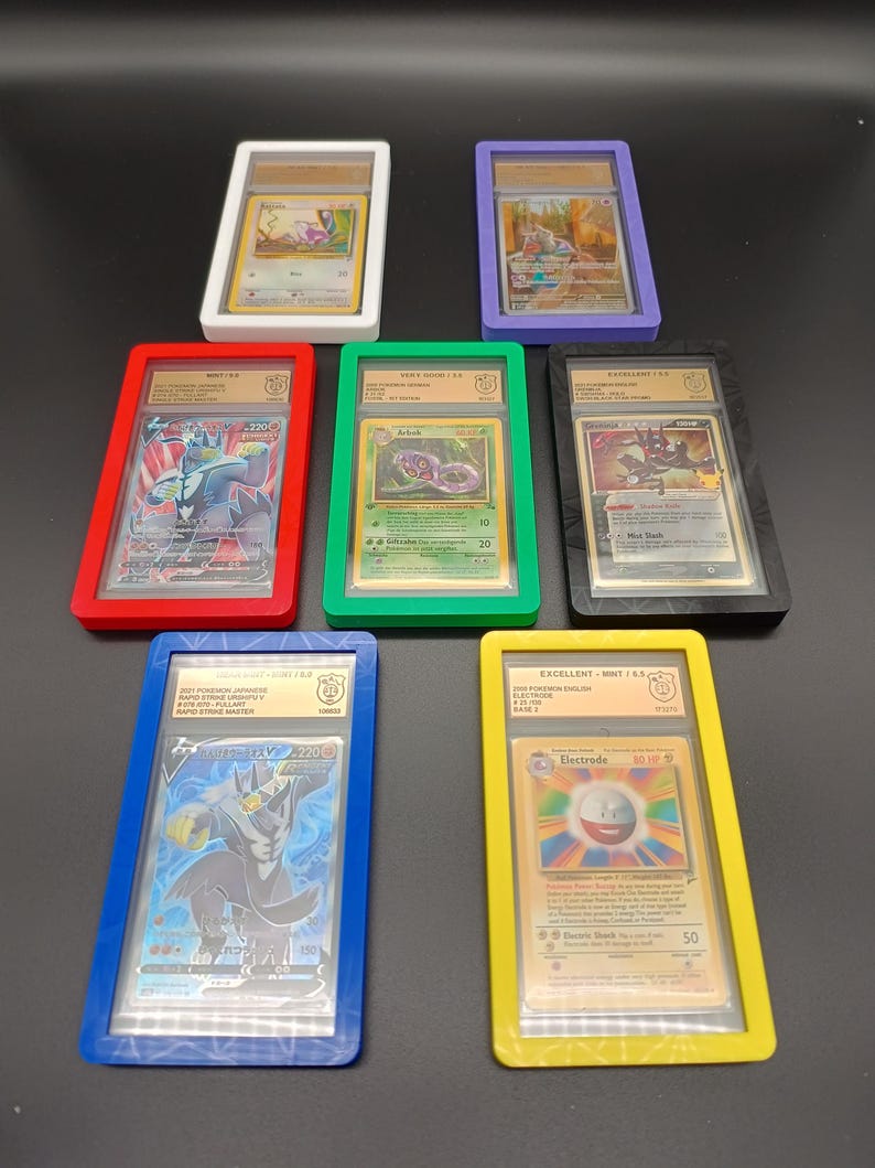 May include: Seven Pokemon trading cards in protective plastic cases. The cases are red, blue, green, yellow, white, black, and purple. The cards are graded with a number and a letter. The cards feature different Pokemon characters, including Electrode, Arbok, and Blastoise.