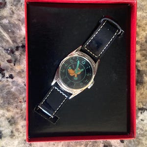 May include: A set of three ceramic mugs with a speckled, matte finish. The mugs are in shades of cream, light gray, and dark gray. Each mug has a simple, modern design and a rounded handle. Perfect for coffee or tea.