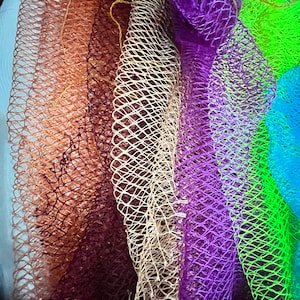 May include: A set of colorful bath poufs in various shades of brown, beige, purple, green, and blue. The poufs are made of a soft, mesh material and are perfect for exfoliating and cleansing the skin.