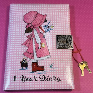 May include: A white ceramic mug with a black handle and the text "But first, coffee" in a handwritten style. The mug is on a white surface. The mug is 4 inches tall.