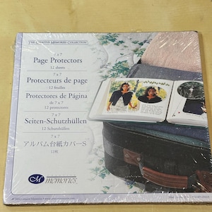 May include: A package of Creative Memories 7x7 inch page protectors. The clear plastic packaging displays the product details, including the text "Page Protectors" and "12 sheets." The package also shows a glimpse of a photo album.