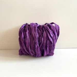 May include: A bundle of purple silk ribbon, ideal for adding a touch of elegance to crafts, gifts, and home decor.