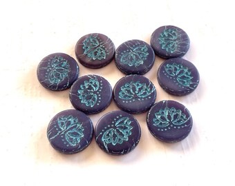 May include: Ten round, dark purple, ceramic beads with a teal blue floral design.