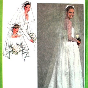May include: A vintage Simplicity sewing pattern for a wedding dress and veil. The pattern number is 9420. The pattern is for one size and is unique.