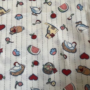 May include: White fabric with a repeating pattern of various farm animals, including chickens, rabbits, cats, and watermelons. The fabric also features hearts, birds, and baskets of flowers.