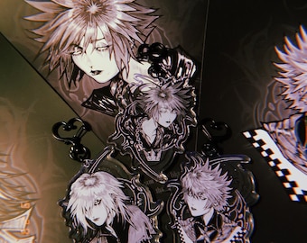 May include: Three acrylic keychains featuring black and white anime-style illustrations of characters from Kingdom Hearts. Each charm displays a unique character portrait with intricate line work, dark accents, and black heart-shaped clasps.