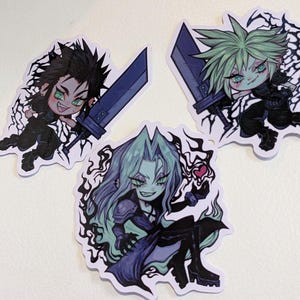 May include: Three cartoon stickers featuring characters from the Final Fantasy VII video game. The stickers are printed on white paper with black outlines. The characters are Cloud, Sephiroth, and Aerith. Cloud is holding a sword and has spiky blonde hair. Sephiroth has long black hair and is holding a sword. Aerith has long green hair and is holding a flower.