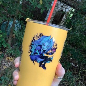 May include: A yellow stainless steel tumbler with a blue and purple anime character sticker. The character is holding a heart-shaped object. The tumbler has a red straw.