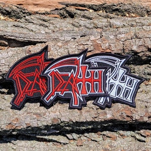 May include: Three embroidered patches featuring the word "DEATH" in black, white, and red lettering. Each patch has a stylized scythe design.