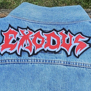 May include: A blue denim jacket with a red and white embroidered patch that says "EXODUS" on the back.