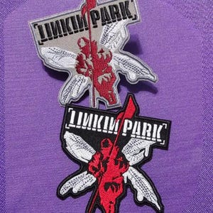 May include: Two black and white embroidered patches with the text "Linkin Park" in white. The patches feature a stylized red insect with wings.