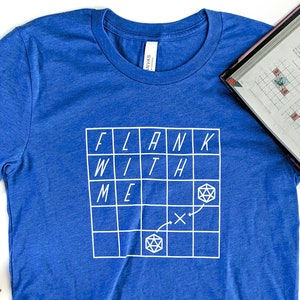 May include: A royal blue t-shirt with a white graphic of a grid with the words "FLANK WITH ME" and a dice symbol.