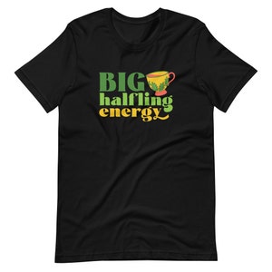 May include: Black t-shirt with green and yellow text that reads "BIG halfling energy" and a cartoon image of a teacup.