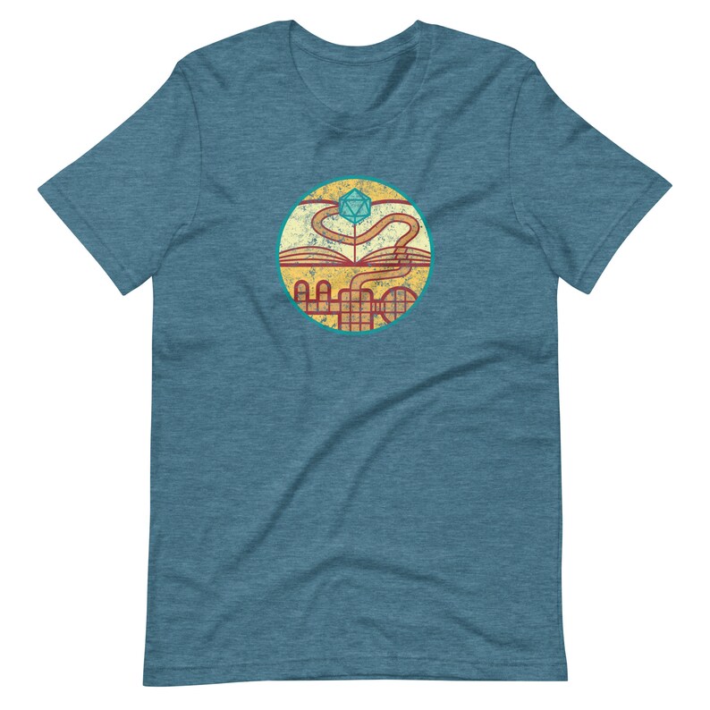 May include: A teal blue t-shirt with a circular graphic of a book with a winding path leading to a blue and green twenty-sided die.