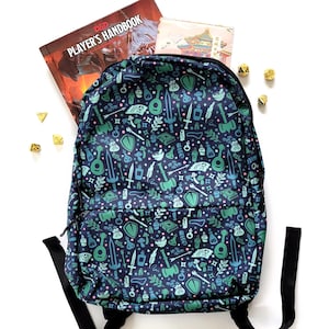 May include: A blue backpack with a green, white, and pink pattern of various fantasy and role-playing game symbols. The backpack has a zipper closure and adjustable straps.