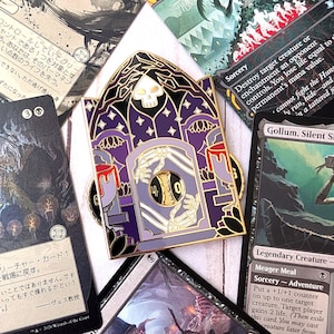 May include: A gold-toned metal enamel pin shaped like a gothic archway with purple and black details. The design features a white skull at the top, skeletal hands reaching through a central doorway, and a rotating gold dial displaying the numbers 4 and 0.