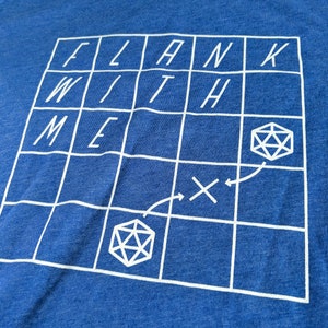 May include: A blue t-shirt with a white grid pattern and the words "FLANK WITH ME" printed on it. The grid has two dice symbols and arrows indicating a path.