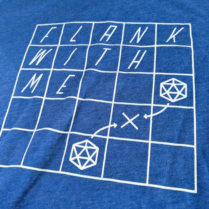 May include: A blue t-shirt with a white grid pattern and the words "FLANK WITH ME" printed on it. The grid has two dice symbols and arrows indicating a path.