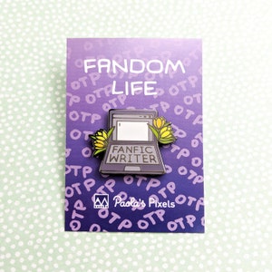 May include: A purple enamel pin with a laptop computer design. The laptop has the words "Fanfic Writer" on the screen. The laptop is surrounded by yellow flowers. The pin has the words "Fandom Life" and "Paola's Pixels" on it.