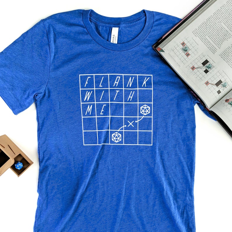 May include: A royal blue t-shirt with a white graphic of a grid with the words "FLANK WITH ME" and a dice symbol.