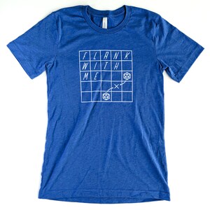 May include: A royal blue t-shirt with a white graphic of a grid with the words "FLANK WITH ME" and a dice symbol.