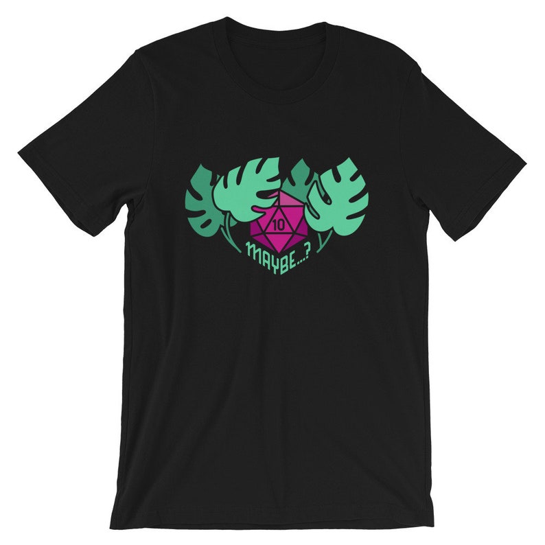 Puede incluir: Camiseta negra con un gr&aacute;fico verde y rosa de un dado con el n&uacute;mero 10 y el texto "MAYBE...?" rodeado de hojas verdes.