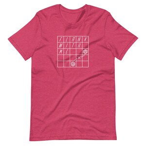 May include: A red t-shirt with a white graphic of a grid with the words "FLANK WITH ME" and a dice symbol.