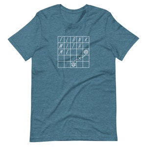 May include: A teal blue t-shirt with a white graphic of a grid with the words "FLANK WITH ME" and a dice symbol.