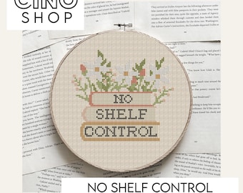 May include: A cross stitch pattern for a hoop with the text "No Shelf Control" in a brown, orange, and white color scheme. The hoop is surrounded by a floral design with pink, white, and green flowers.