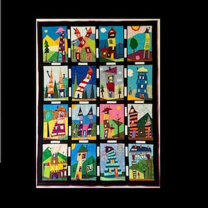 May include: A colorful, handmade quilt featuring twelve unique, whimsical house designs. Each house is depicted in a rectangular panel with vibrant colors and various architectural styles, set against a black background.