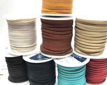 May include: Spools of leather cord in various colors, including black, white, brown, tan, turquoise, and red. The cords are wound around white spools.