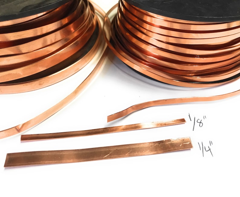 May include: Two spools of copper wire, one 1/8 inch thick and one 1/4 inch thick. The wire is wound around the spools and is a shiny copper colour.