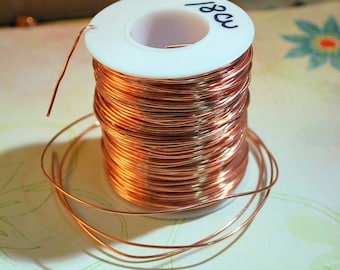 May include: A spool of copper wire with a white plastic label that says "18ga".