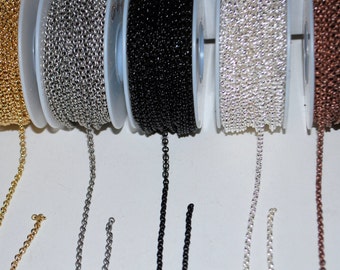 May include: Close-up of six spools of chain, each in a different color: gold, silver, black, white, copper, and brown. The chains are all the same size and style.