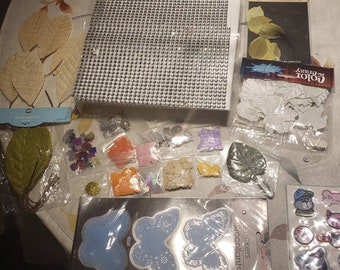 Lot of new and opened packages of leaves, butterflies silver adhesives, confetti. Etc. CD4